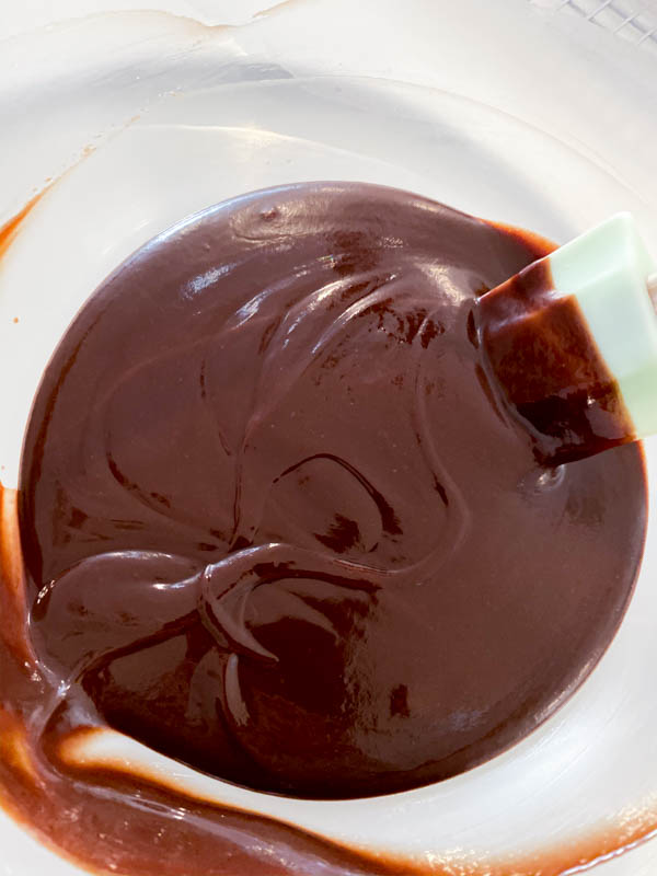 Chocolate Ganache in a bowl with a spatula.