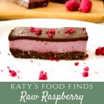 A slice of Raw Raspberry Chocolate Slice on a white plate with a sprinkling of freeze dried raspberries and 2 slices in background.