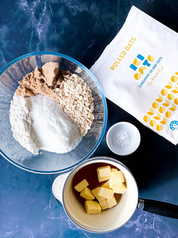 Looking down on a bench with the ingredients laid out for Anzac Biscuits.