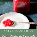 A jar of Easy Rhubarb Compote in the background on a black marble bench, with a spoonful of compote on a spoon, on a white plate.