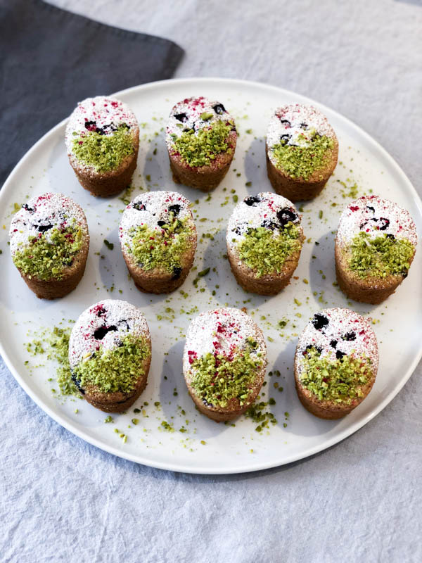 Looking down on a platter of Pistachio Blueberry Friands.