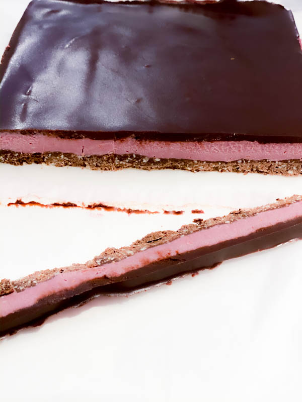 The slab of Raw Raspberry Chocolate Slice with an end trimmed off.