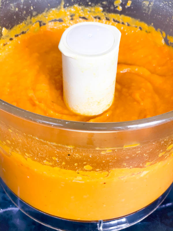Roasted Pumpkin and vegetables blended until smooth and creamy in the bowl of a food processor.