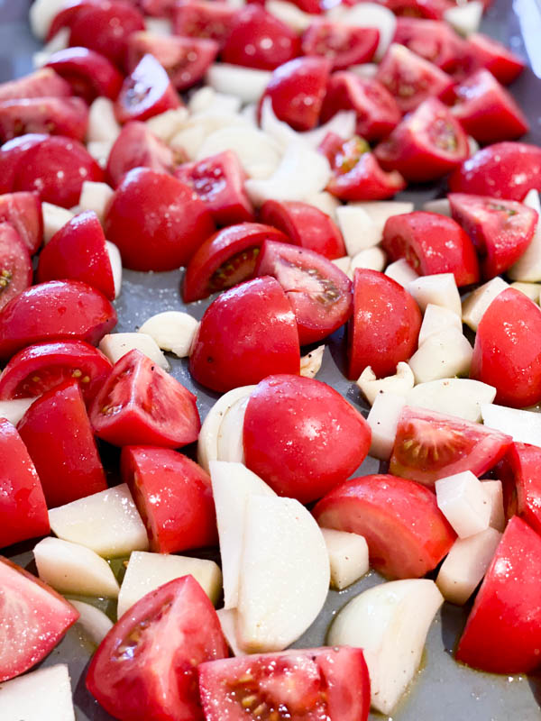 Chopped Tomatoes, Onion and Garlic on Roasting Tray.