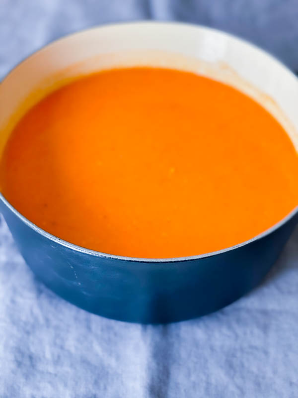 Roasted Tomato Soup in a blue pot after its been blended until smooth and creamy.