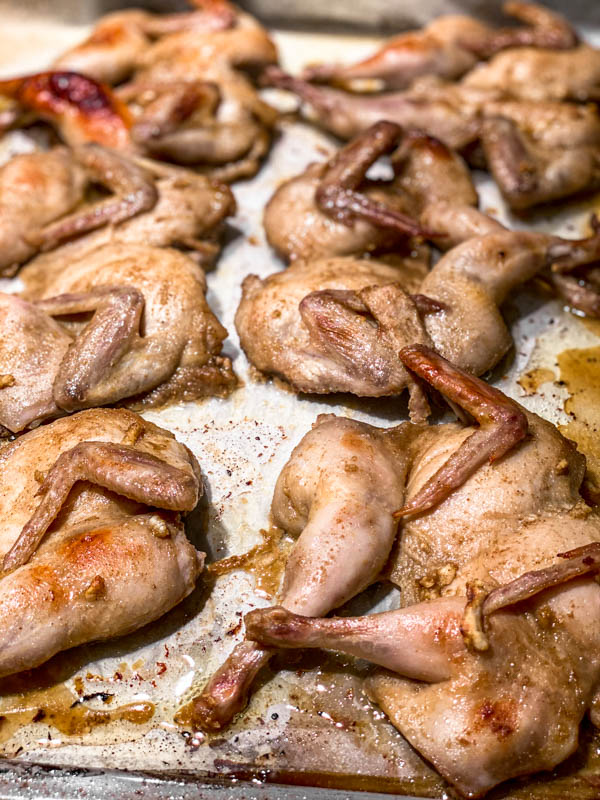 Showing the butterflied Quail half-way through cooking time, so after 10 minutes in the oven. It has browned slightly.
