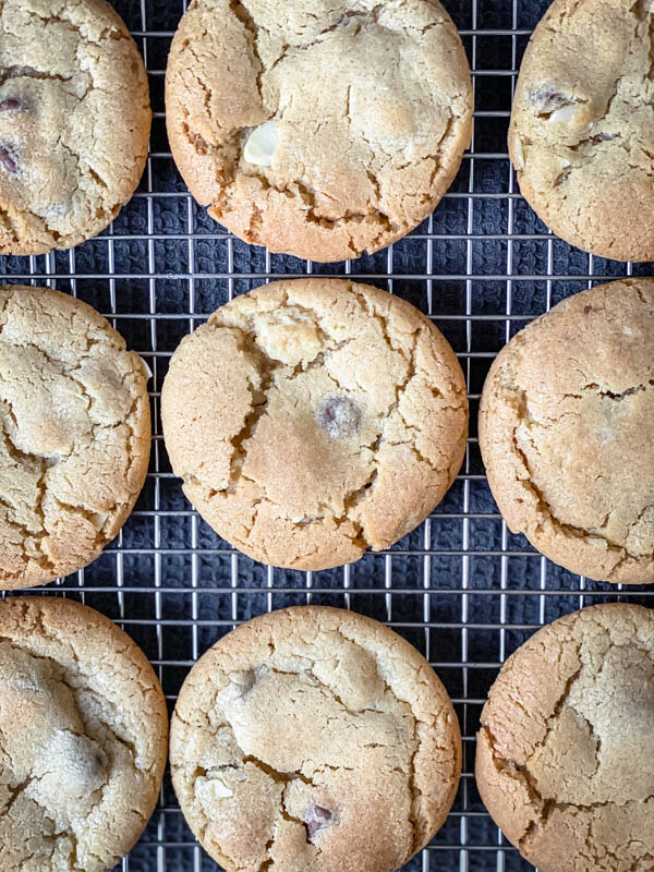 A close up and looking down onto Gingernut Biscuits resting on a wire cooling rack.