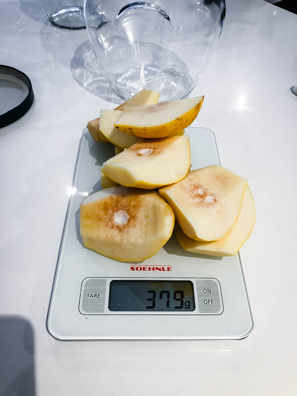 Quarters of Quince on kitchen scales showing the measurement of 379g.