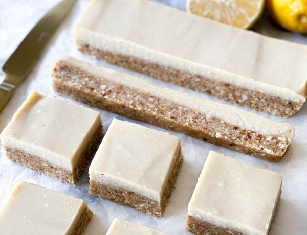 Close up side view of the Raw Lemon Slice cut into squares with a knife on the side.
