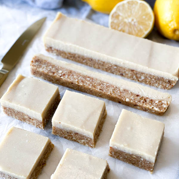 Close up side view of the Raw Lemon Slice cut into squares with a knife on the side.