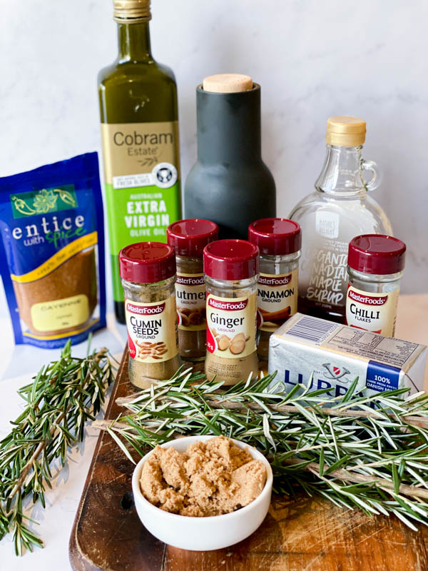 All the ingredients required to make Sweet and Spicy Nuts on a white marble bench.