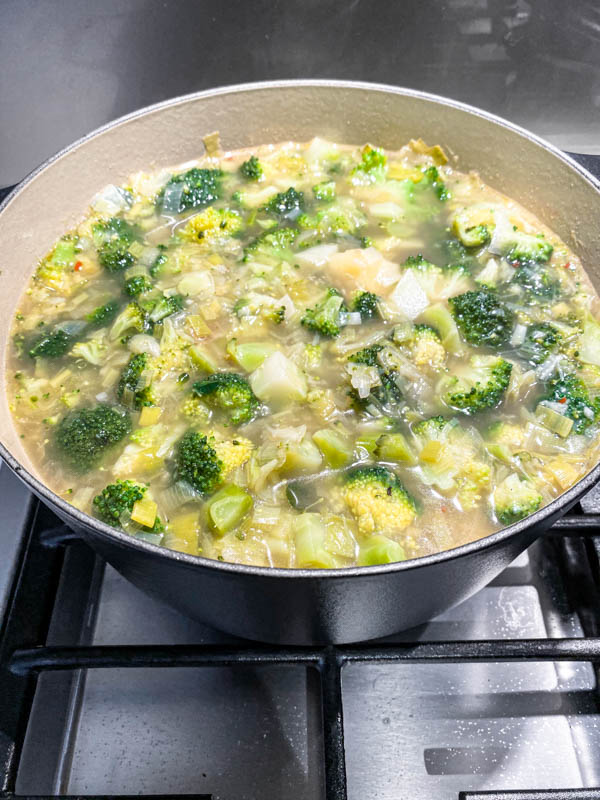 The finished soup just before it is blended. It shows the broccoli florets are now softened along with the potatoes and broccoli stems.
