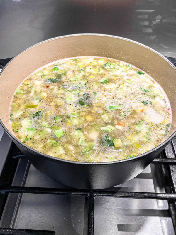 The stock has now been added to the pot of leeks, potato and chopped broccoli stems so that they are all covered. This will be brought to the boil.