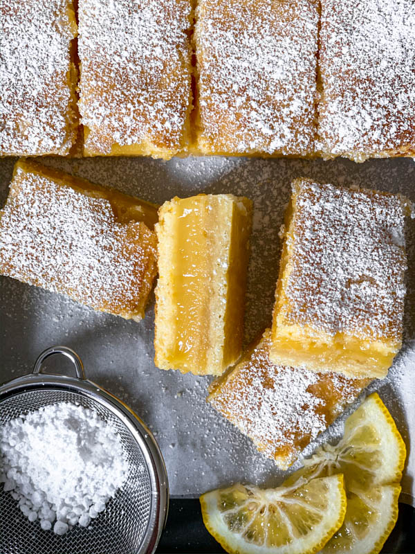 Looking down on some of the Gooey Yuzu Slice as a close up, dusted with icing sugar.