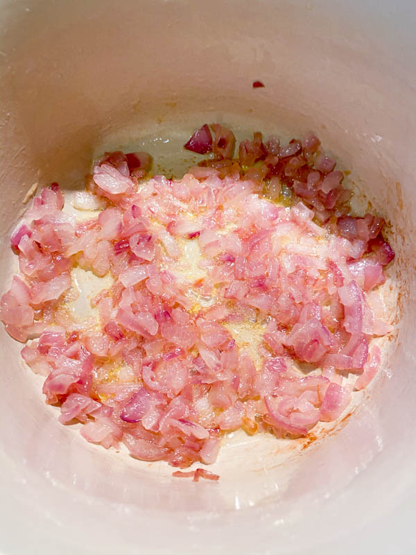 Looking into the pot of sautéed and softened chopped red onion.