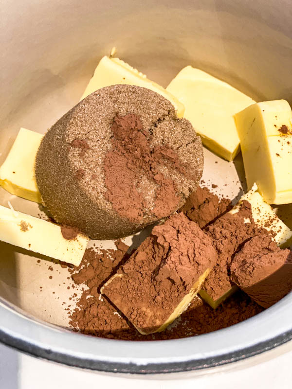 The brown sugar, butter and cocoa in a pot ready to be melted.