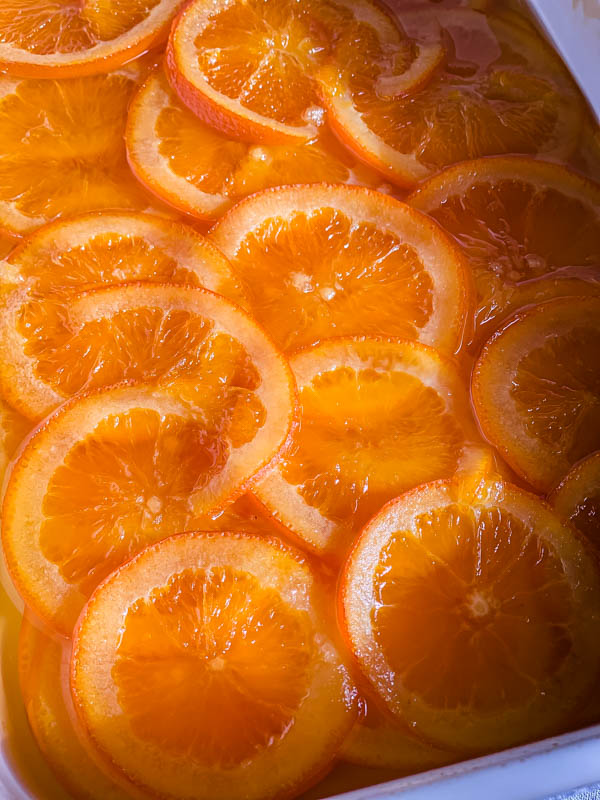 Close up of the confit orange slices that are soft and translucent.