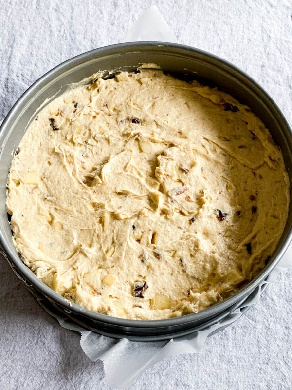 The cake batter is in the lined cake tin ready to go into the oven.