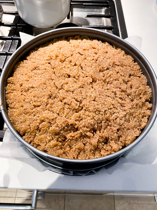 The cake has been baking and now has the coconut topping spread out evenly over the cake and it’s ready to be put back into the oven to finish off.