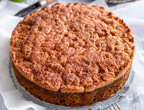 The Lumberjack Cake on a white tablecoth. It is still sittting in the base of the cake tin, with the sides removed.