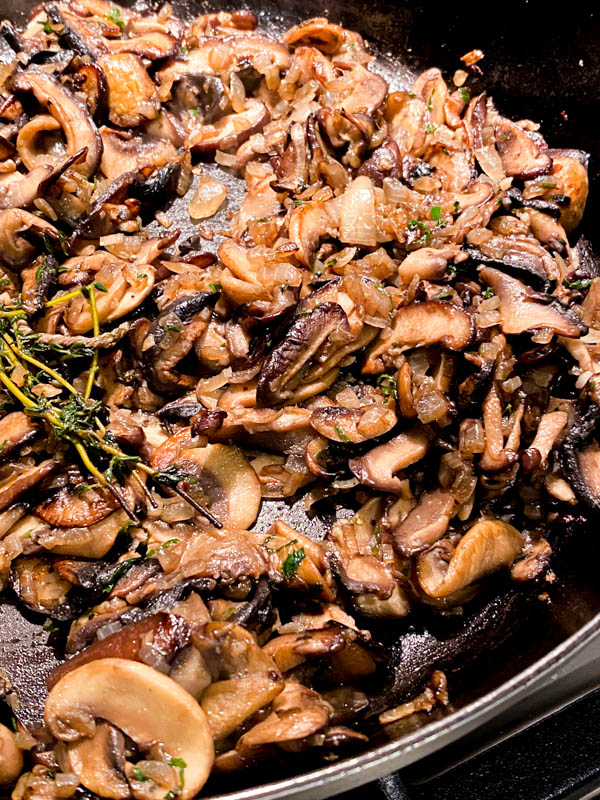 The mushrooms are now ready. This shows that they are nicely browned and slightly caramelised, with no liquid left in the pan.