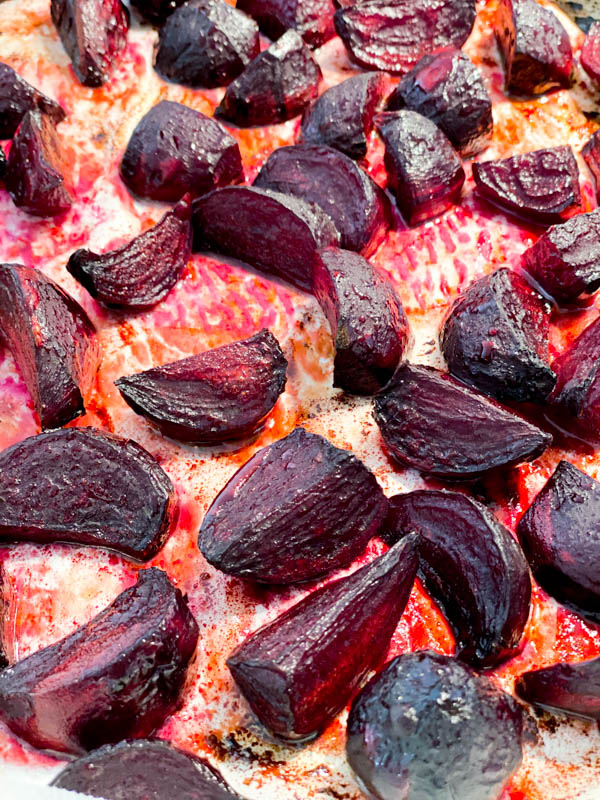 Roasted wedges of baby beetroots on the oven tray.