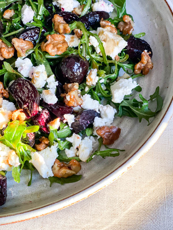 Close up of the Roast Beetroot, Goats Cheese and Walnut Salad on a large round white platter.