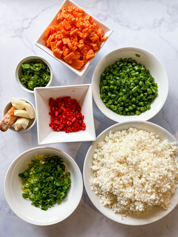 The vegetables for the Cauliflower Fried Rice are prepared, chopped and in bowls.