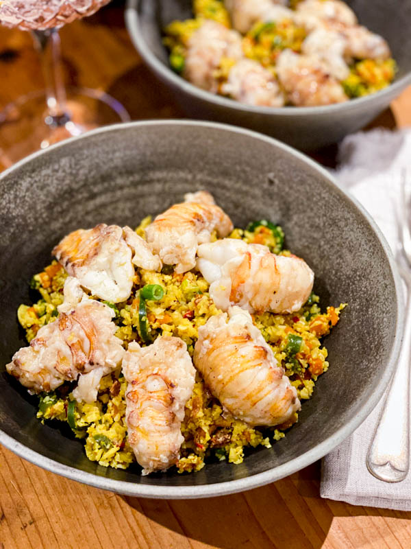 The Cauliflower Fried Rice is served here with Moreton Bay Bugs on top in two bowls, ready to be eaten.