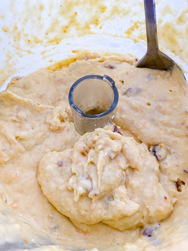 The dry and wet ingredients are now combined to form a batter, ready for spooning into the muffin tin.