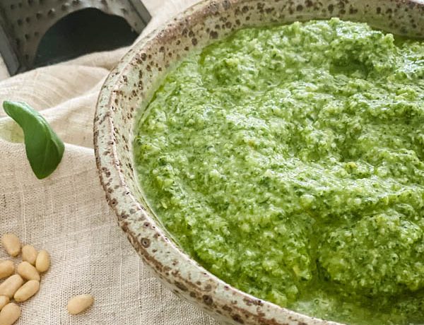 A close-up of the bowl of Basil Pesto with a mini cheese grater in the background.