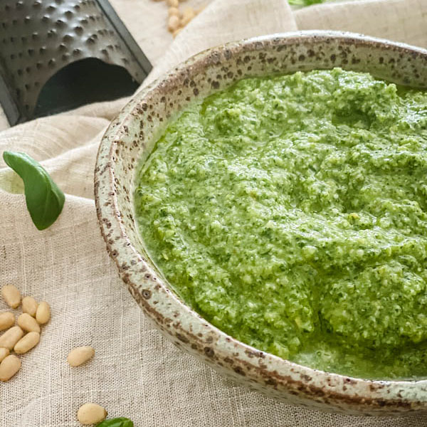 A close-up of the bowl of Basil Pesto with a mini cheese grater in the background.