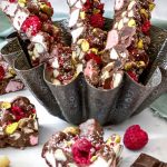 The 3 cut slices of Christmas Rocky Road reveal all the colours of the ingredients within.