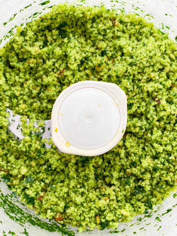 The beautiful green herb crust is now processed and shown in the bowl of the food processor.