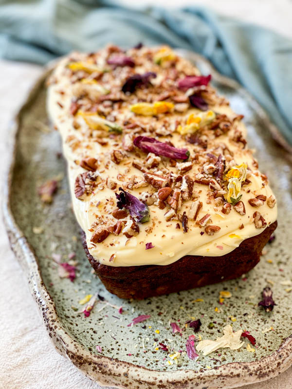 The Banana Cake is now decorated with Cream Cheese Frosting with chopped walnuts and dried flowers sprinkled on top.