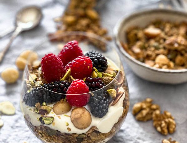 A close up of the parfait glass with granola, yoghurt and fresh berries.