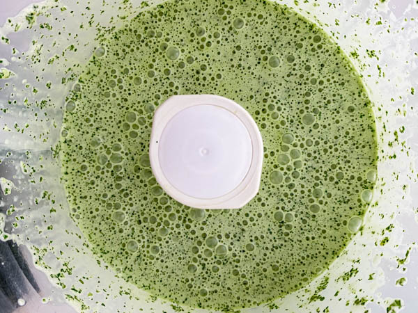 Looking into the bowl of the food processor with the now prepared Mint Dressing.