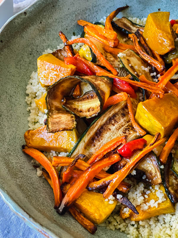 The grilled vegetables are sitting on top of the herby lemon couscous ready for the dressing.