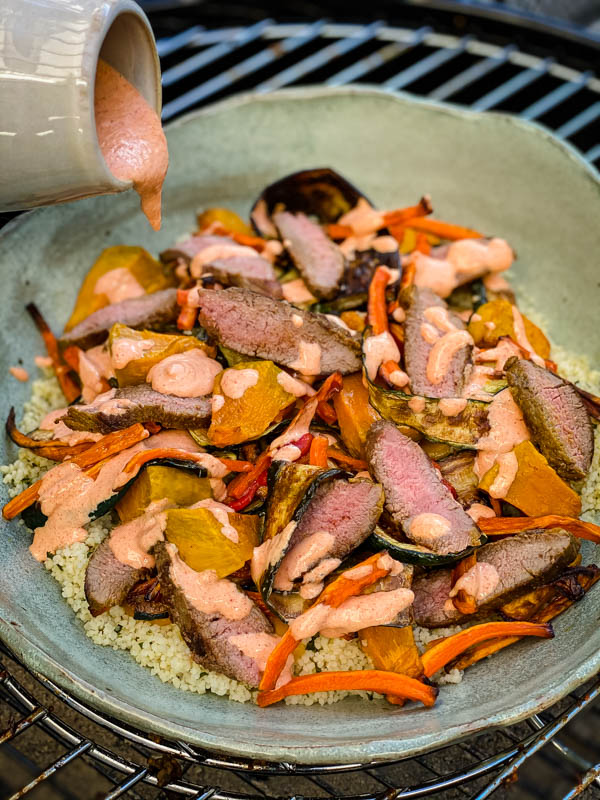 The Red Pepper Mayo is being poured onto the salad.