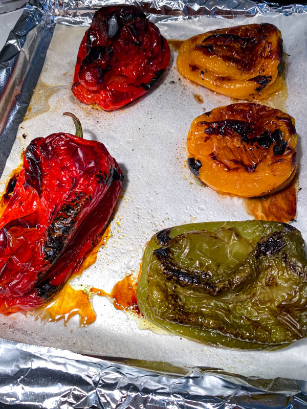 Grilled Peppers on an oven tray lined with foil and baking paper