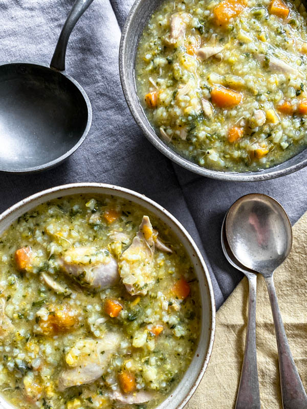 A close up of the two soup bowls filled with soup.