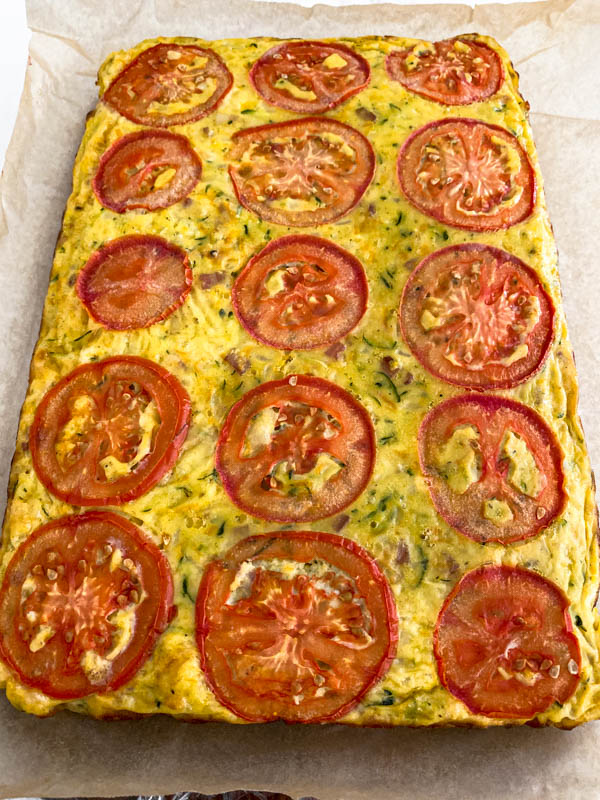 Looking down onto a slab of zucchini slice ready to be cut.