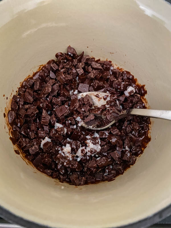 Chocolate pieces and coconut oil in a small saucepan ready to be melted.