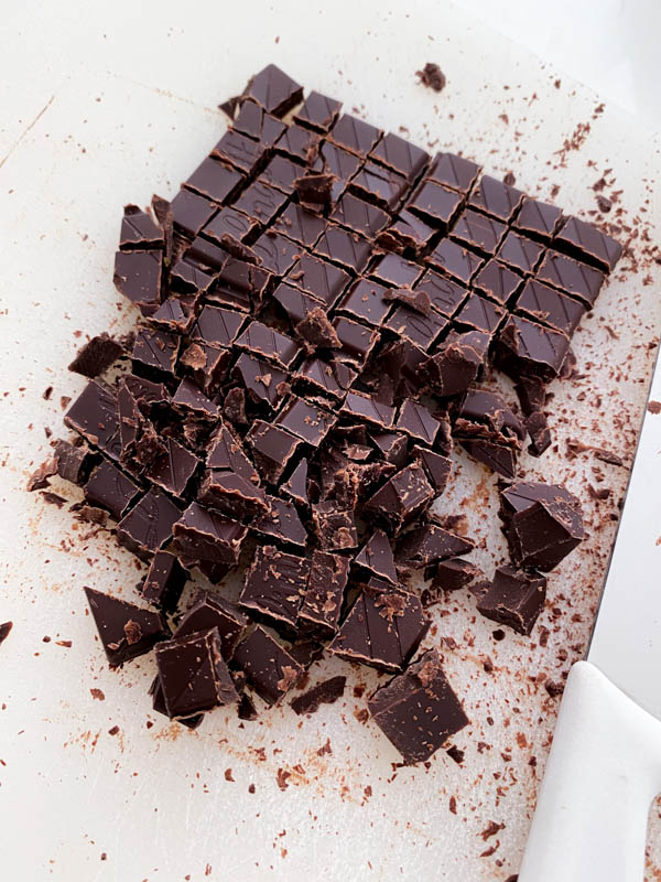 The block of dark chocolate has been cut into small chunks.