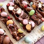 Slices of the Easter Rocky Road on a serving platter on a pink tablecloth.