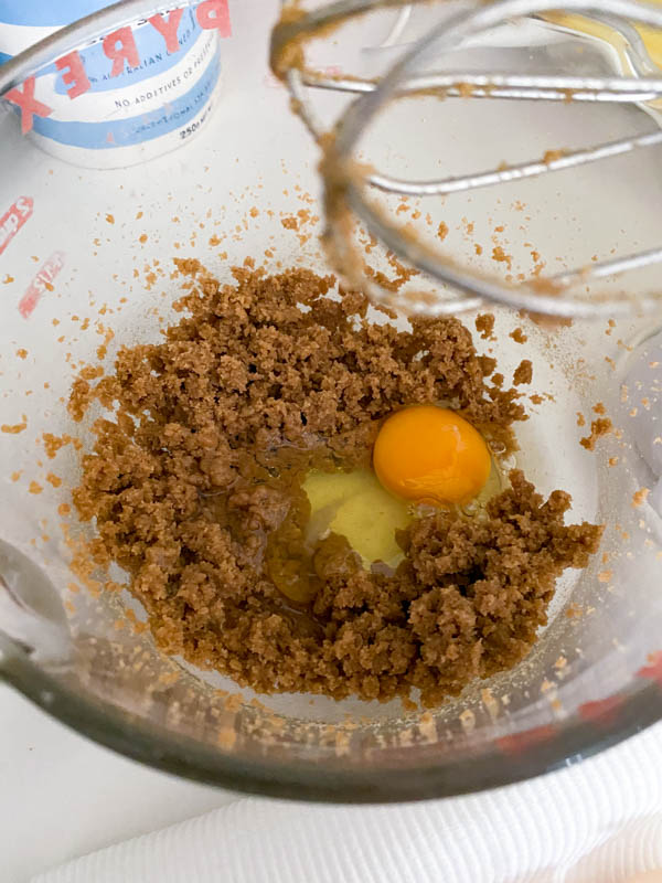 The brown sugar and butter have been creamed in the bowl and an egg is now added.