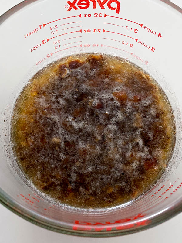 The dates and baking soda are in a bowl soaking with boiling water.