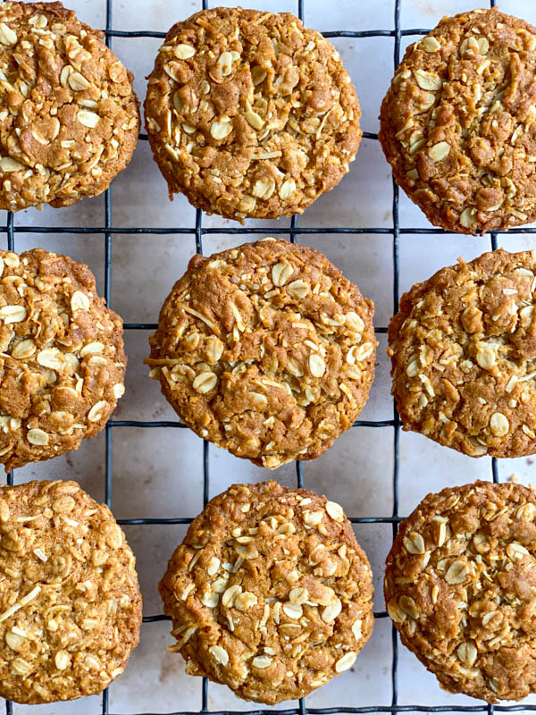 Looking down onto a close up of 9 biscuits cooling on a black wire cooling rack.