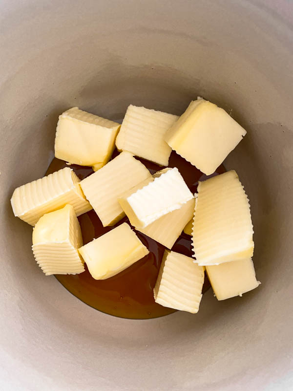 Cubes of butter and the golden syrup are in a saucepan ready to be melted.