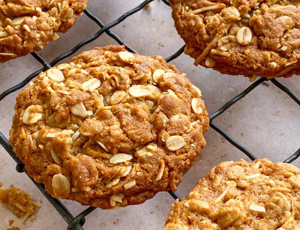 A side on view of one of the Chewy Anzac Biscuits resting on the wire cooling rack.